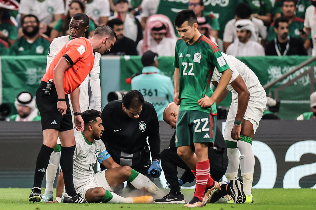 Image: Saudi Arabia's midfielder #10 Salem Al-Dawsari receives medical treatment during the Qatar 2022 World Cup (Karim Jaafar / AFP - Getty Images)