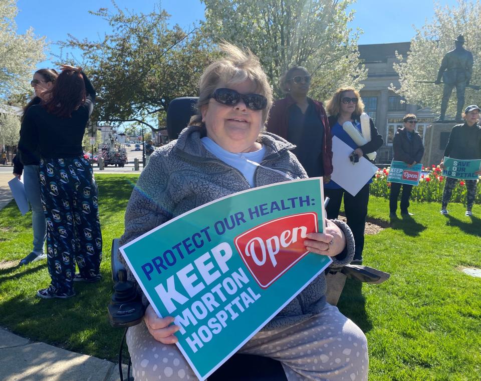 Taunton resident Shelly Pearl holds a sign at the community rally to save Morton Hospital held on the Taunton Green on Tuesday, April 23, 2024.