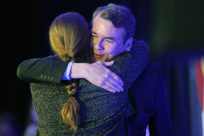 Incumbent Sen. Michael Bennet, D-Colo., right, hugs Morgan Carroll, the state Democratic Party chairperson, before Bennet speaks during an election watch party Tuesday, Nov. 8, 2022, in downtown Denver. (AP Photo/David Zalubowski)