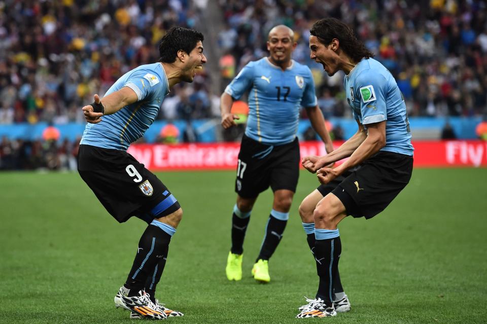 Uruguay strikers Luis Suarez and Edinson Cavani celebrate during a group stage win over England at the 2014 World Cup. Their group is much easier this time around. (Getty)