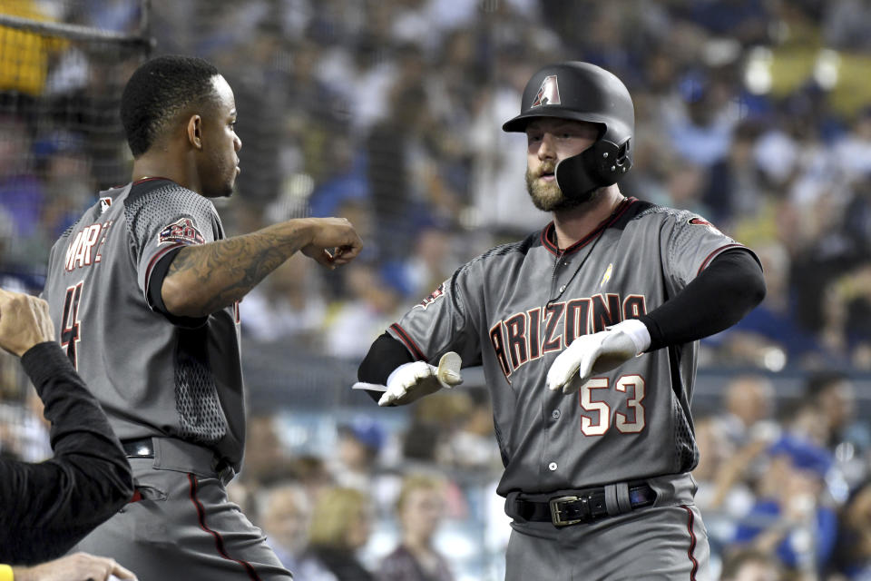Arizona Diamondbacks' Christian Walker (53) is congratulated by Ketel Marte after hitting a solo home run in the sixth inning of a baseball game against the Los Angeles Dodgers, Saturday, Sept. 1, 2018, in Los Angeles. (AP Photo/Michael Owen Baker)