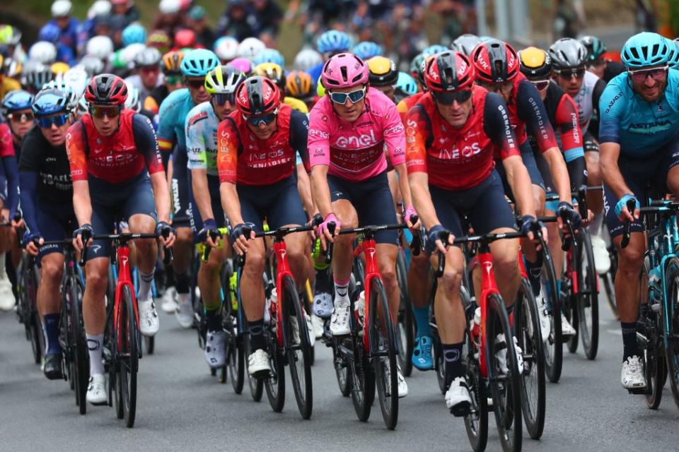 Overall leader INEOS Grenadierss British rider Geraint Thomas C and fellow riders cycle in the pack during the eleventh stage of the Giro dItalia 2023 cycling race 219 km between Camaiore and Tortona on May 17 2023 Photo by Luca Bettini  AFP Photo by LUCA BETTINIAFP via Getty Images