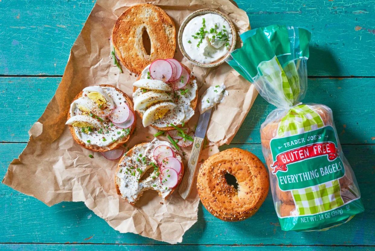 Spread showing Trader Joe's gluten-free bagels with cream cheese, egg, radish, and other toppings