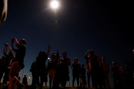 A police helicopter shines a light on protesters as they march in reaction to the not guilty verdict in the murder trial of Jason Stockley, a former St. Louis police officer, charged with the 2011 shooting of Anthony Lamar Smith, who was black, in St. Louis, Missouri, U.S., September 15, 2017. REUTERS/Whitney Curtis/