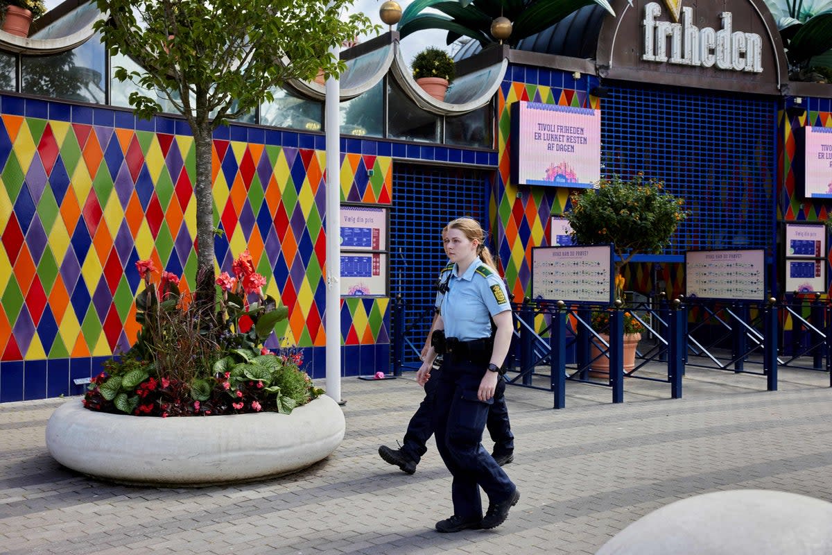 Police walk outside the closed Tivoli Friheden amusement park, in Aarhus, western Denmark on 14 July 2022 (Ritzau Scanpix/AFP via Getty Ima)