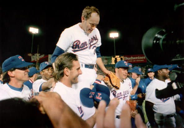 <p><strong>May 1, 1991</strong>: At Arlington Stadium, the legendary but badly banged-up Nolan Ryan, age 44, takes the mound for the Texas Rangers against Toronto. After holding the Blue Jays hitless for the first eight and two-thirds innings, Ryan has only Roberto Alamar standing in the way of an unprecedented seventh no-no. With the count at 2-2, Ryan's final pitch starts to the plate and explodes at 93 miles per hour as Alomar swings and misses. Bedlam is on parade at Arlington. Ryan's teammates surge out on the field, lifting him onto their shoulders. "My teammates were excited for me and involved in it," the righty told Harvey Frommer, author of Ryan's biography <em><a href="https://www.amazon.com/Throwing-Heat-Autobiography-Nolan-Ryan/dp/038524438X?tag=syn-yahoo-20&ascsubtag=%5Bartid%7C10054.g.28170941%5Bsrc%7Cyahoo-us" rel="nofollow noopener" target="_blank" data-ylk="slk:Throwing Heat;elm:context_link;itc:0;sec:content-canvas" class="link ">Throwing Heat</a></em>, "and the fans rallied."<br> </p>