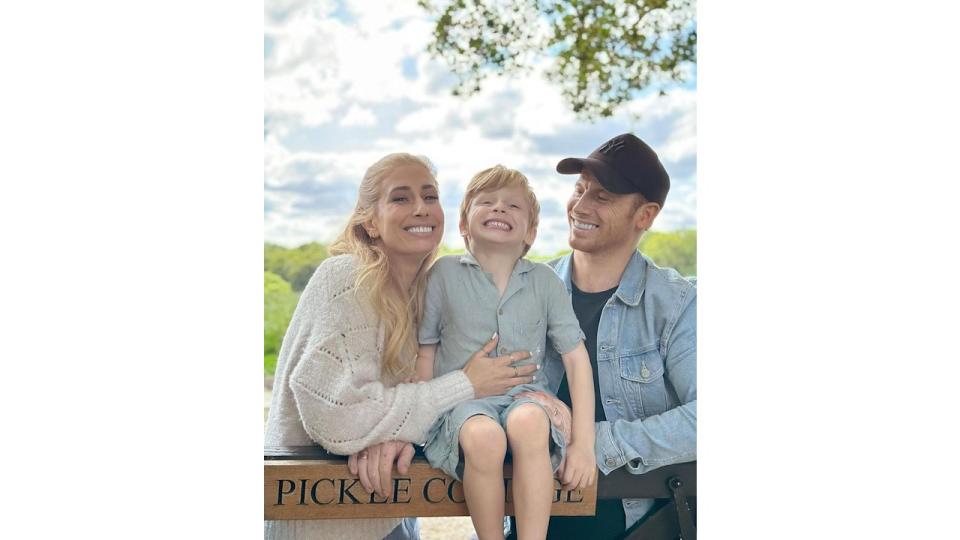 Stacey Solomon and her husband Joe Swash with their son Rex sitting on the fence