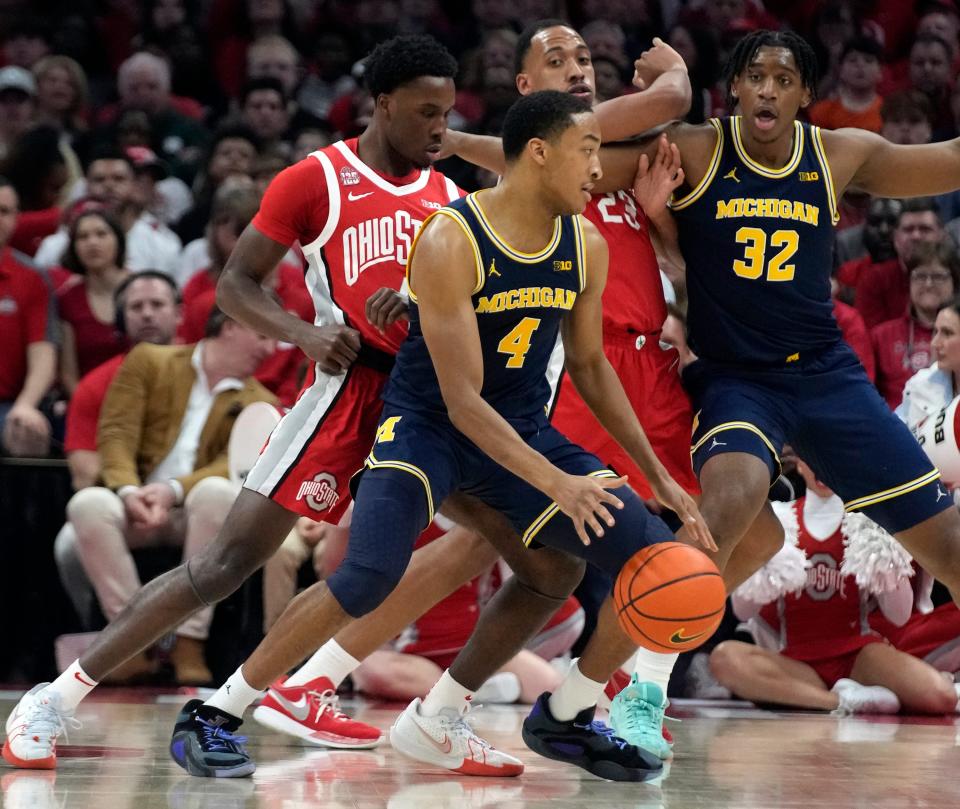 Michigan's Nimari Burnett looks for a pass while guarded by Ohio State's Dale Bonner at Value City Arena, March 3, 2024 in Columbus, Ohio.