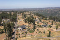 Homes on Wagstaff Road in Paradise, Calif., are shown on Friday, June 14, 2024. Last month, the Rebuild Paradise Foundation launched the Defensible Space Gravel Grant. It’s a voucher for up to $500 that residents can redeem at a local rock seller — enough to cover a 5-foot-wide perimeter around a 2,000 square foot home in base rock. (AP Photo/Nic Coury)