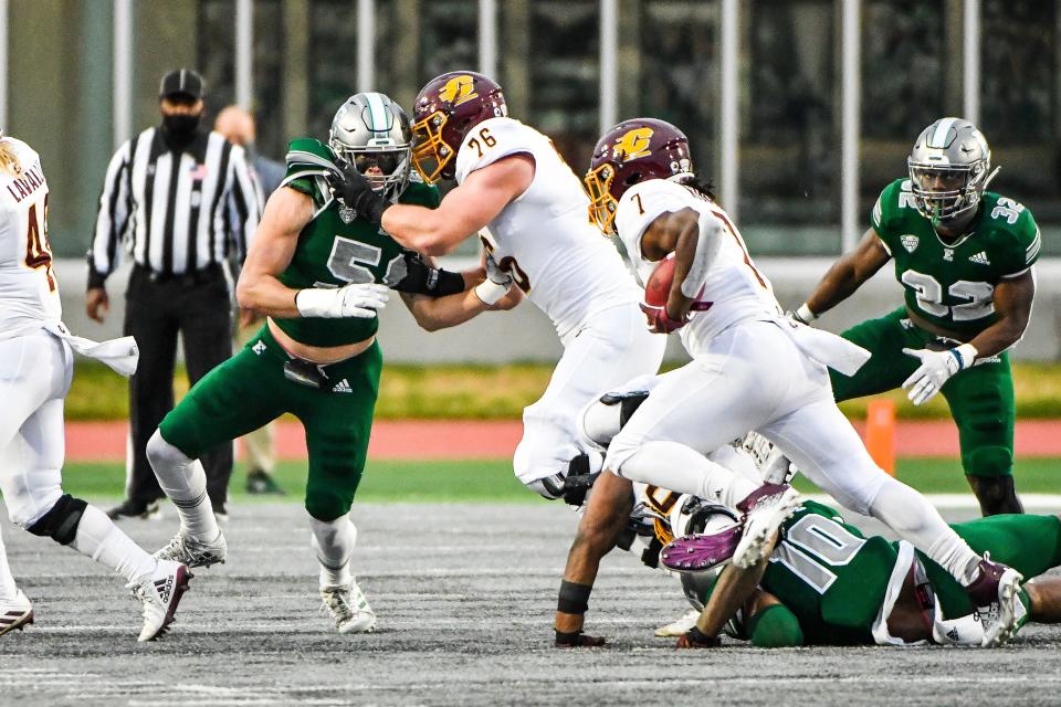 Central Michigan Chippewas running back Lew Nichols III (7) runs wide behind the block of Central Michigan Chippewas offensive lineman Bernhard Raimann (76) during a game vs. Eastern Michigan on Friday Nov. 27, 2020 at Rynearson Stadium in Ypsilanti.