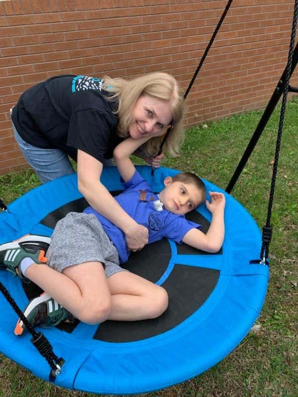 Volunteer Teresa Clark gives camper Caleb Wingfield a push on a swing at Forever His Bible Day Camp held at Karns Church of Christ Saturday, April 15, 2023.