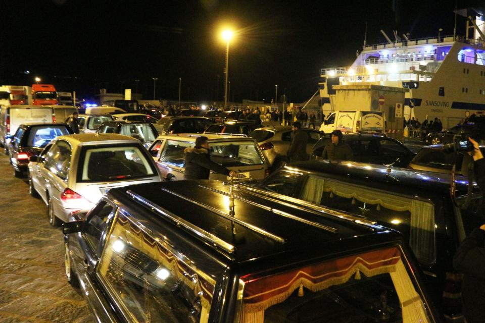 The coffins with the bodies of immigrants who died trying to reach the Italian coast arrive from Lampedusa on February 11, 2015 in Porto Empedocle where they will be buried in cemeteries of the area. More than 300 migrants are feared drowned after their overcrowded dinghies sank in the Mediterranean, triggering calls for the world to act after the latest boat disaster in a perilous crossing from Africa to Europe. The victims were mainly from sub-Saharan Africa who had left the coast of conflict-wracked Libya at the weekend in four small inflatable boats, the UN refugee agency said.   AFP PHOTO / MARCELLO PATERNOSTRO        (Photo credit should read MARCELLO PATERNOSTRO/AFP/Getty Images)