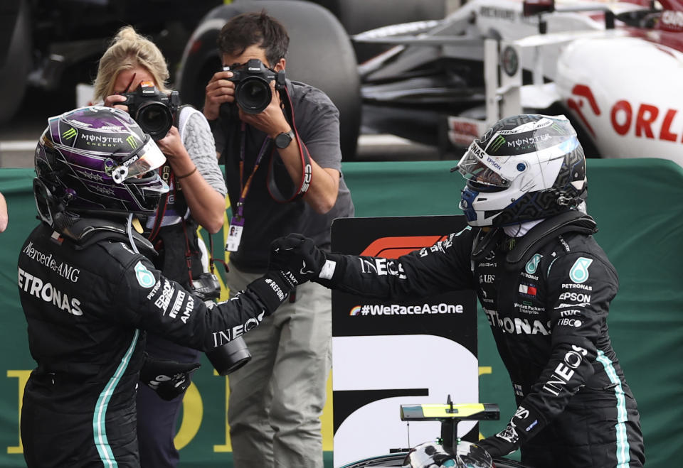 Race winner Mercedes driver Lewis Hamilton of Britain, left, celebrates with second placed Mercedes driver Valtteri Bottas of Finland after the Formula One Grand Prix at the Spa-Francorchamps racetrack in Spa, Belgium, Sunday, Aug. 30, 2020. (Lars Baron, Pool via AP)