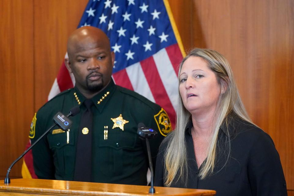 Broward Sheriff's Office Cold Case Unit Sgt. Kami Floyd, right, speaks as Sheriff Gregory Tony looks on during a news conference, Tuesday, June 7, 2022, at the BSO Public Safety Building in Fort Lauderdale, Fla. Authorities announced that they were able to identify and charge a man known as the "Pillowcase Rapist," Robert Koehler, for multiple sexual assault cases in Broward County in the 1980's. (AP Photo/Wilfredo Lee)