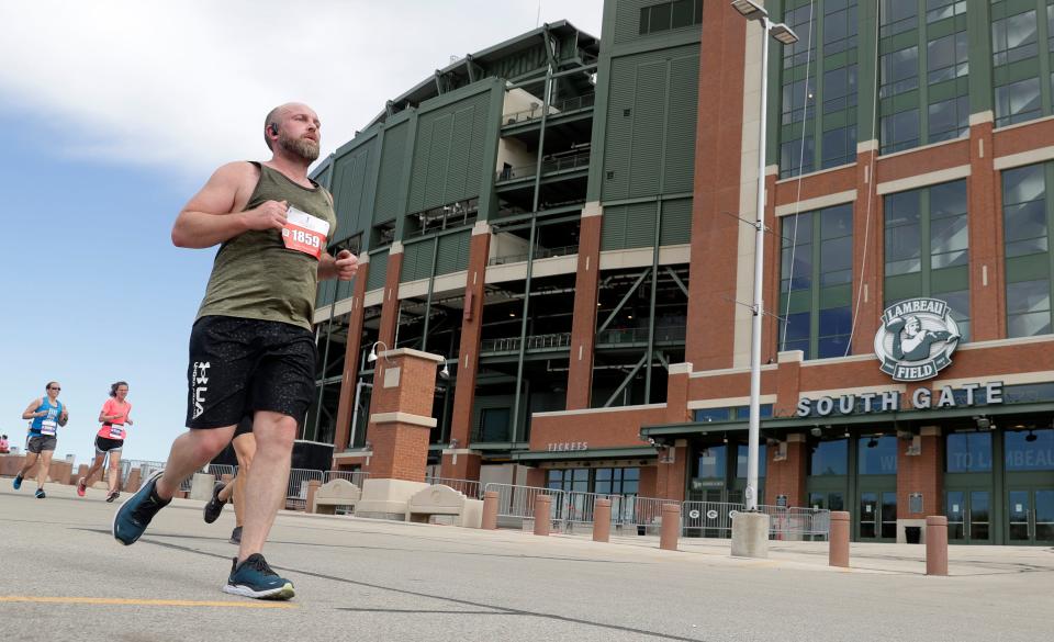 Michael Kennedy of Appleton runs past Lambeau Field while participating in the half marathon portion of the Cellcom Green Bay Marathon on Sunday in Green Bay.