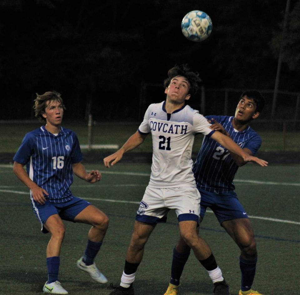 Covington Catholic's Aiden Leach (21) heads the ball with pressure from Highlands' Adarsh Khullar (27) and Peyton Helminiak (16). Reigning Ninth Region CovCath aims for another title with Highlands one of the top challengers.