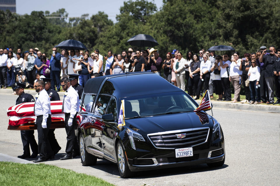 The casket of Los Angeles Police Department Officer Juan Jose Diaz is carried at Forest Lawn Hollywood Hills cemetery, Monday, Aug. 12, 2019, in Los Angeles. Diaz was killed while off duty in Lincoln Heights after visiting a taco stand. (Sarah Reingewirtz/The Orange County Register via AP)