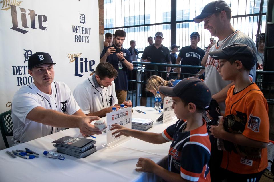 Tigers pitcher Tarik Skubal signs autographs for Owen Beck  and his sons Braden, 9, Paxton, 6 all of Bowling Green, Ohio during the Summer Baseball Bash at Comerica Park in Detroit, Saturday, July 17, 2021.