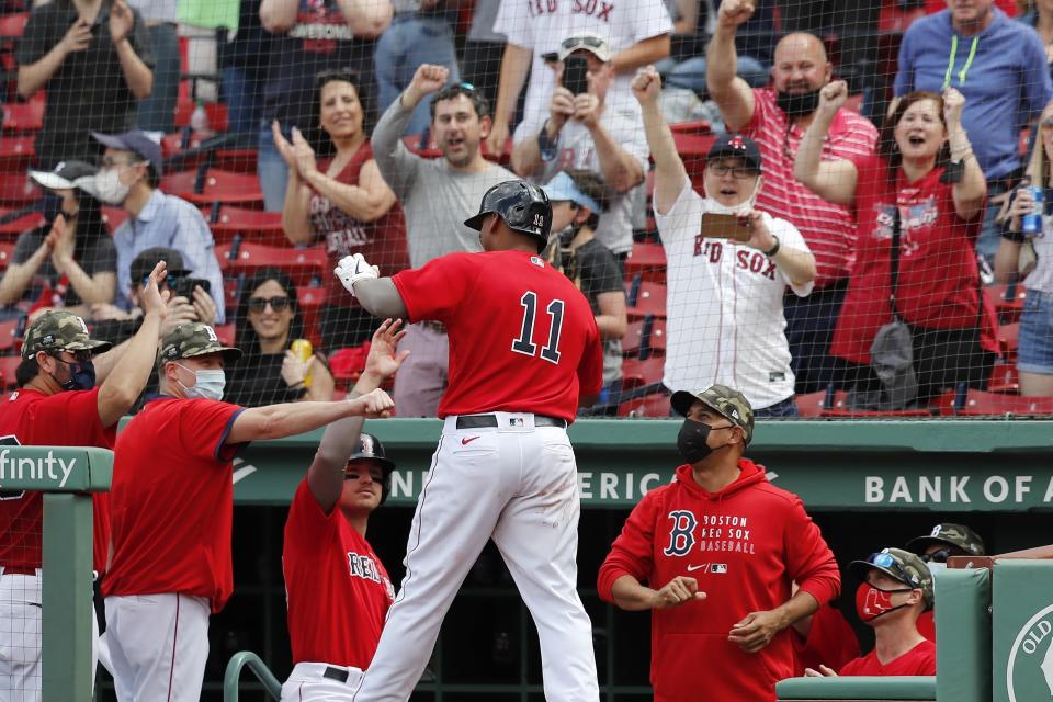 Boston Red Sox's Rafael Devers (11) celebrates his three-run home run during the fifth inning of a baseball game against the Los Angeles Angels, Sunday, May 16, 2021, in Boston. (AP Photo/Michael Dwyer)