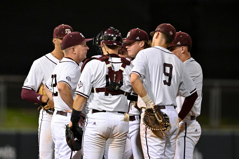 Texas A&M head coach Jim Schlossnagle speaks to his players during a sixth-inning mound visit against Louisville in the College Station Super Regional. The Aggies have swept through the NCAA postseason heading into the College World Series.
