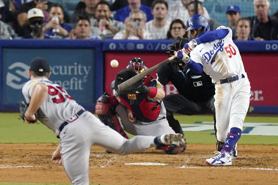 Los Angeles Dodgers' Mookie Betts, right, hits a three-run home run as Atlanta Braves starting pitcher Spencer Strider, left, watches along with catcher Sean Murphy, second from left, and home plate umpire Dan Bellino during the fifth inning of a baseball game Thursday, Aug. 31, 2023, in Los Angeles. (AP Photo/Mark J. Terrill)