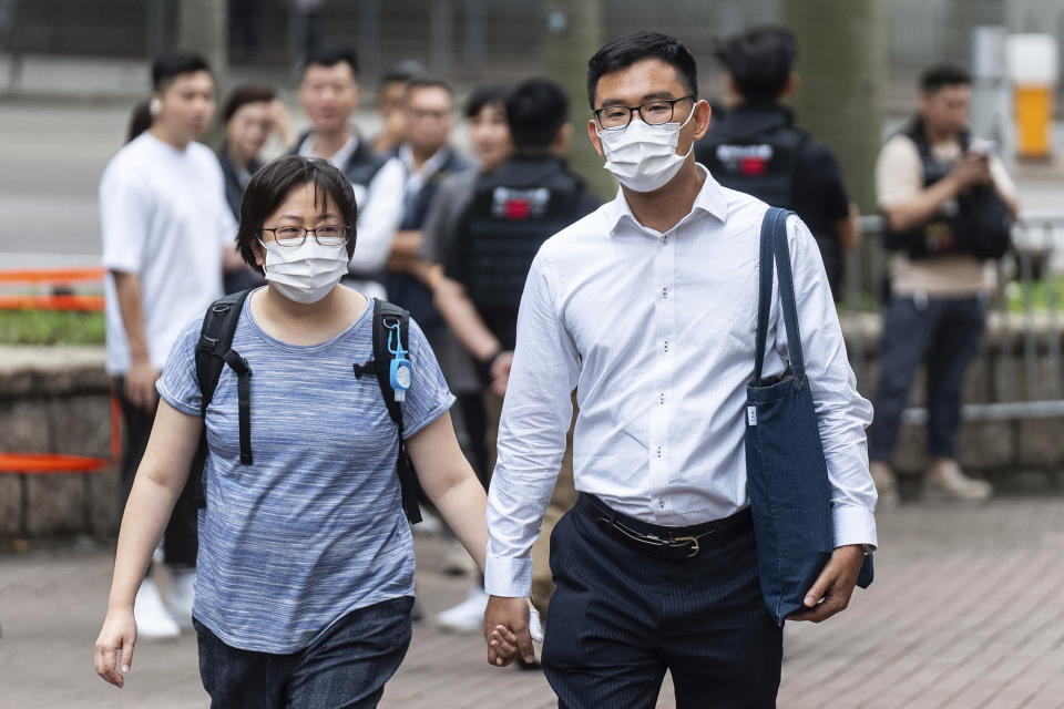 Sze Tak-loy, right, a former pro-democracy district councilor, arrives at the West Kowloon Magistrates' Courts in Hong Kong, Thursday, May 30, 2024. (AP Photo/Chan Long Hei)