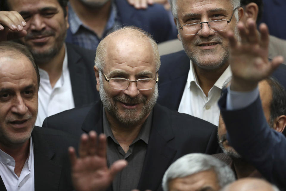 Mohammad Bagher Qalibaf, center, is surrounded by a group of lawmakers after being elected as speaker of the parliament, in Tehran, Iran, Thursday, May 28, 2020. Iran's parliament voted Thursday to elect Qalibaf, a hard-line former mayor of Tehran as the legislative body's new speaker. (AP Photo/Vahid Salemi)