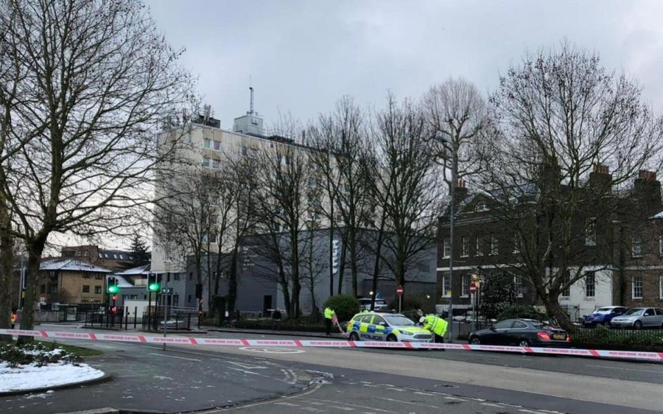 Investigators at work in Forest Road, east London, where a 21-year-old woman has died after being hit by a police car responding to a 999 call - PA