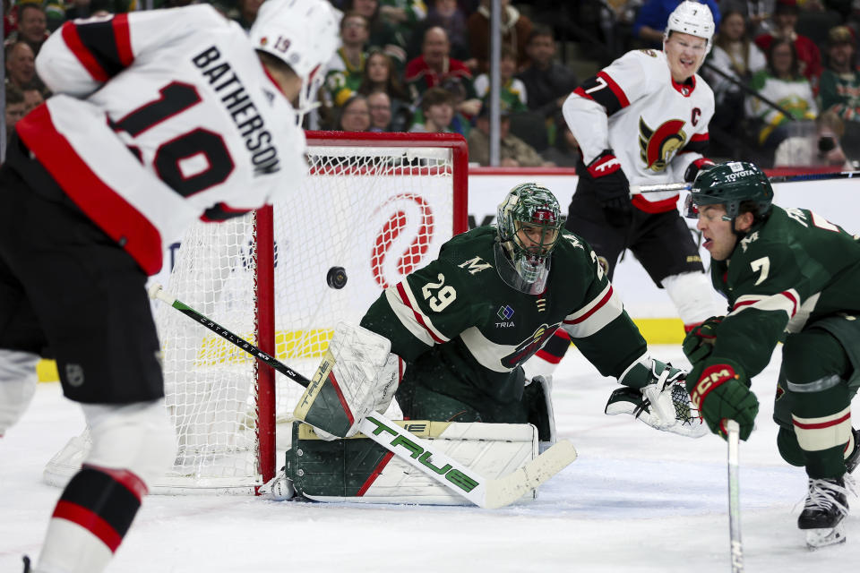 Ottawa Senators right wing Drake Batherson, left, scores a goal passes Minnesota Wild goaltender Marc-Andre Fleury (29) during the second period of an NHL hockey game Tuesday, April 2, 2024, in St. Paul, Minn. (AP Photo/Matt Krohn)