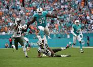 <p>Miami Dolphins defensive tackle Jordan Phillips (97) leaps over New York Jets wide receiver Robby Anderson (11) after making an interception during the second half at Hard Rock Stadium. The Dolphins won 27-23. Mandatory Credit: Steve Mitchell-USA TODAY Sports </p>