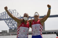 Martin Sinkovic and Valent Sinkovic of Croatia celebrate after winning the gold medal in the men's rowing pair final at the 2020 Summer Olympics, Thursday, July 29, 2021, in Tokyo, Japan. (AP Photo/Darron Cummings