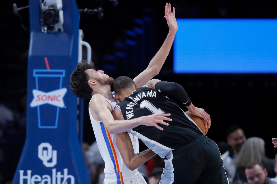Oklahoma City Thunder forward Chet Holmgren (7) is called for a foul as he collides with San Antonio Spurs center Victor Wembanyama (1) during an NBA preseason basketball game between the Oklahoma City Thunder and the San Antonio Spurs at Paycom Center in Oklahoma City, Monday, Oct. 9, 2023.