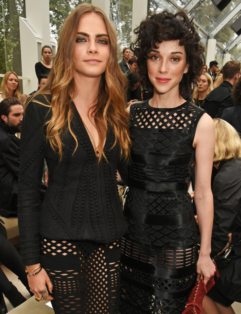 Cara Delevingne (L) and Annie Clark pose at the Burberry Womenswear Spring/Summer 2016 show during London Fashion Week 