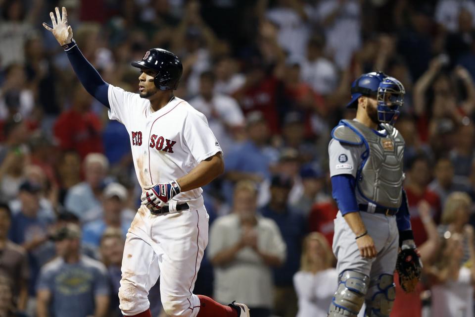 Boston Red Sox's Xander Bogaerts, left, celebrates his solo home run as Los Angeles Dodgers' Russell Martin looks away during the eighth inning of a baseball game in Boston, Sunday, July 14, 2019. (AP Photo/Michael Dwyer)