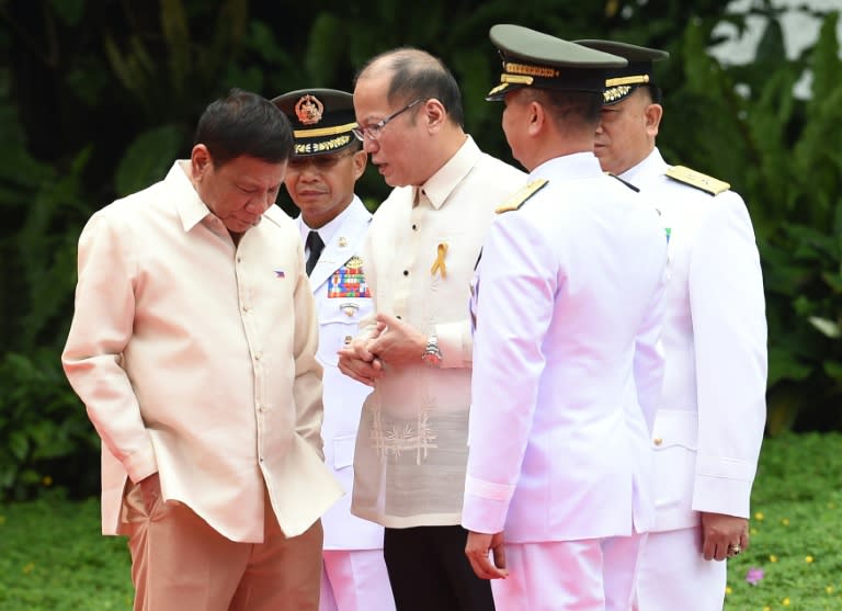 Incoming Philippines President Rodrigo Duterte (L) listens to outgoing President Benigno Aquino ahead of his swearing-in ceremony at Malacanang Palace in Manila on June 30, 2016