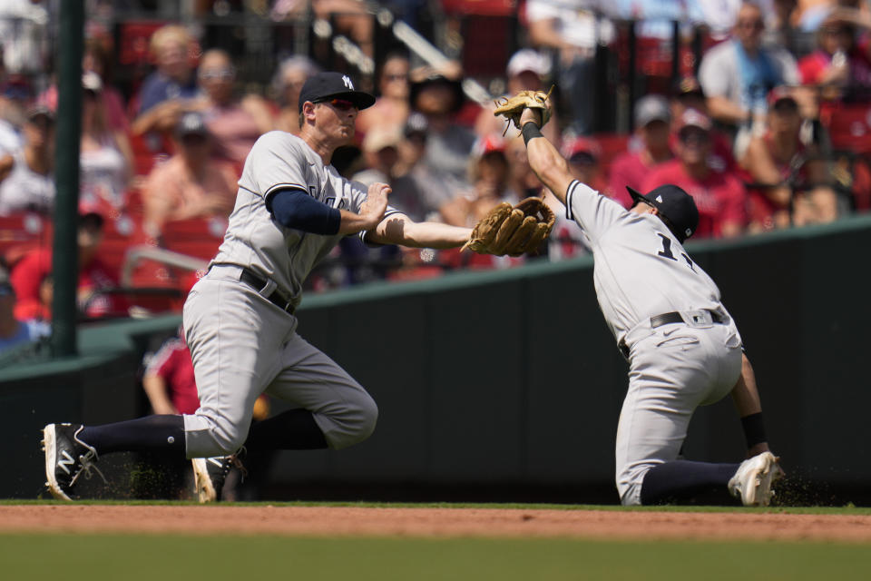 New York Yankees shortstop Anthony Volpe, right, nearly collides with teammate DJ LeMahieu while catching a fly ball by St. Louis Cardinals' Lars Nootbaar during the fifth inning of a baseball game Sunday, July 2, 2023, in St. Louis. (AP Photo/Jeff Roberson)