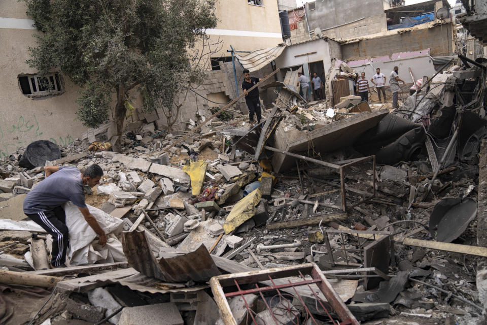 Palestinians inspect the rubble of a house after it was struck by an Israeli airstrike in Khan Younis, southern Gaza Strip, Friday, Oct. 27, 2023. (AP Photo/Fatima Shbair)