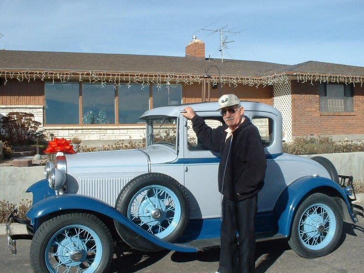 Vernon Callan Phillips stands by a 1930 Model A Ford.