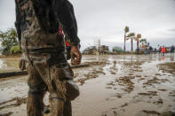 Rescuers work to remove mud after heavy rainfall triggered landslides that collapsed buildings and left as many as 12 people missing, in Casamicciola, on the southern Italian island of Ischia, Saturday, Nov. 26, 2022. Firefighters are working on rescue efforts as reinforcements are being sent from nearby Naples, but are encountering difficulties in reaching the island either by motorboat or helicopter due to the weather. (AP Photo/Salvatore Laporta)