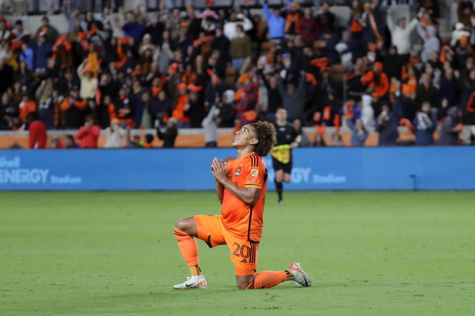 Houston Dynamo midfielder Adalberto Carrasquilla, celebrates at midfield after a win overSporting Kansas City after extra minutes in the second half of an MLS playoff soccer match Sunday, Nov. 26, 2023, in Houston. (AP Photo/Michael Wyke)