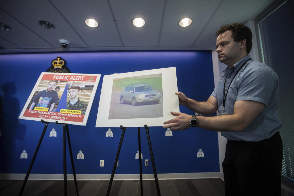 Security camera images of Kam McLeod, 19, and Bryer Schmegelsky, 18, and a Toyota RAV4 SUV are placed on display before an Royal Canadian Mounted Police news conference in Surrey, British Columbia, on Tuesday, July 23, 2019. RCMP say two British Columbia teenagers who were first thought to be missing are now considered suspects in the deaths of three people in northern British Columbia. The bodies of Australian Lucas Fowler, his girlfriend Chynna Deese, of Charlotte, N.C., and an unidentified man were found a few kilometers from the teens' burned-out vehicle. (Darryl Dyck/The Canadian Press via AP)