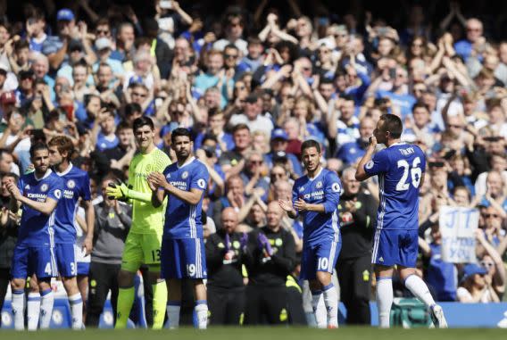 <p>Chelsea’s team captain John Terry kisses the team captain armband as he leaves the pitch applauded by his teammates after being substituted during the English Premier League soccer match between Chelsea and Sunderland at Stamford Bridge stadium in London, Sunday, May 21, 2017. (AP Photo/Kirsty Wigglesworth) </p>