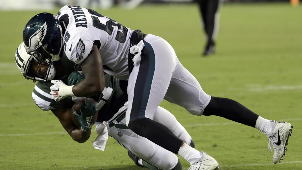 Philadelphia Eagles' LaRoy Reynolds (50) tackles New York Jets' Charone Peake during the second half of a preseason NFL football game Thursday, Aug. 30, 2018, in Philadelphia. (AP Photo/Michael Perez)