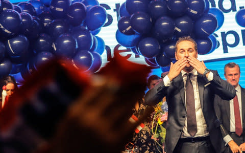 The leader of the right-wing Austrian Freedom Party Heinz-Christian Strache blows kisses to his supporters during an election party. - Credit: Valdrin Xhemaj/EPA