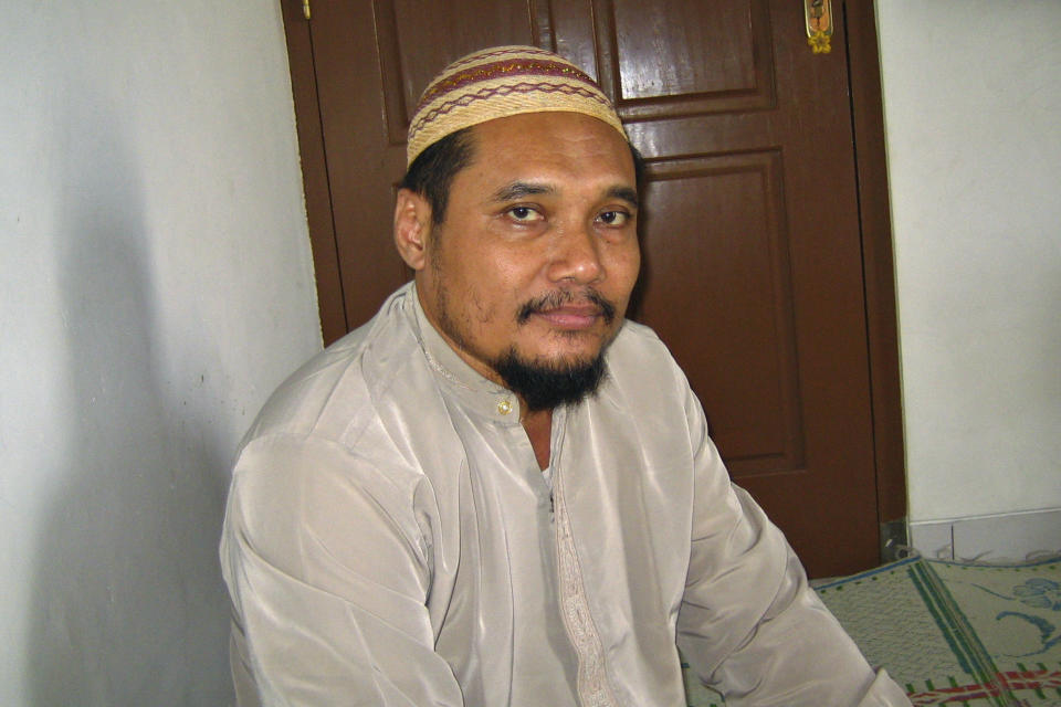 FILE - In this March 16, 2007 file photo, militant cleric Abu Rusdan sits in his family home during an interview with The Associated Press in Kudus, Central Java, Indonesia. Indonesia's elite counterterrorism squad has arrested the convicted militant and suspected leader of an al-Qaida-linked group that has been blamed for a string of past bombings in the country, Indonesia police said Monday, Sept. 13, 2021. (AP Photo/Chris Brummitt, File)