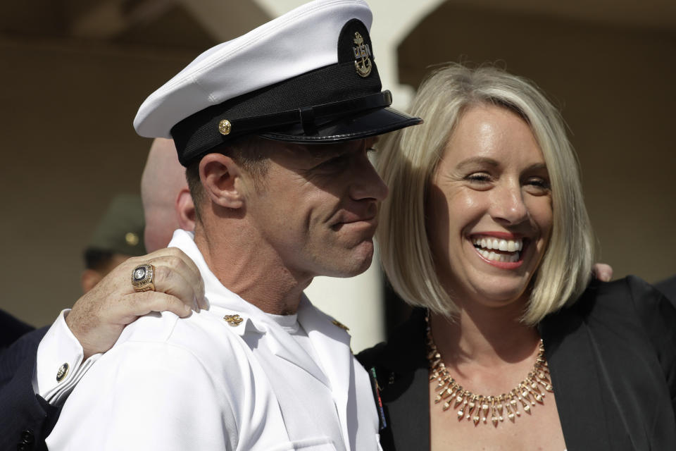 Navy Special Operations Chief Edward Gallagher, left, and his wife, Andrea Gallagher smile, after leaving a military court on Naval Base San Diego, Tuesday, July 2, 2019, in San Diego. A military jury acquitted the decorated Navy SEAL Tuesday of murder in the killing of a wounded Islamic State captive under his care in Iraq in 2017. (AP Photo/Gregory Bull)