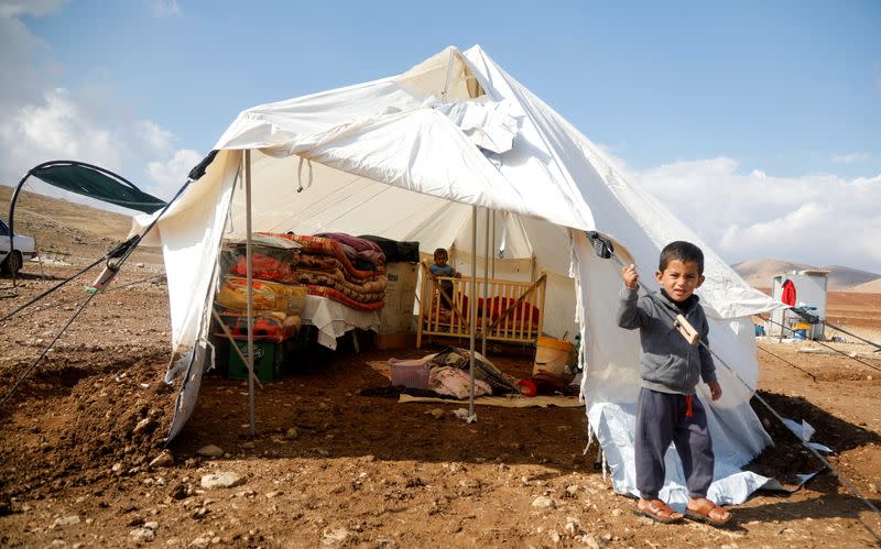 A Palestinian boy, whose family tented home was destroyed, stands outside a tent in Khirbet Humsah in Jordan Valley in the Israeli-occupied West Bank