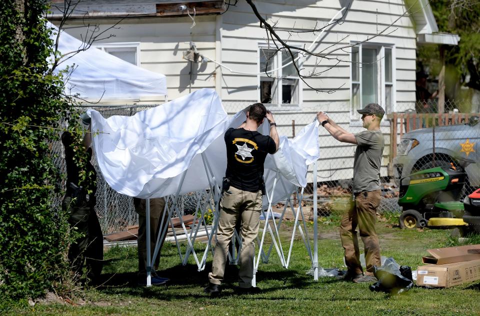 Law enforcement officials put up tents in the yard outside of a home in the 2100 block of South Grand Avenue East on April 15, 2024. Sangamon County Sheriff's Deputies said they took "something of interest" related to a cold case from a house on April 14, 2024.