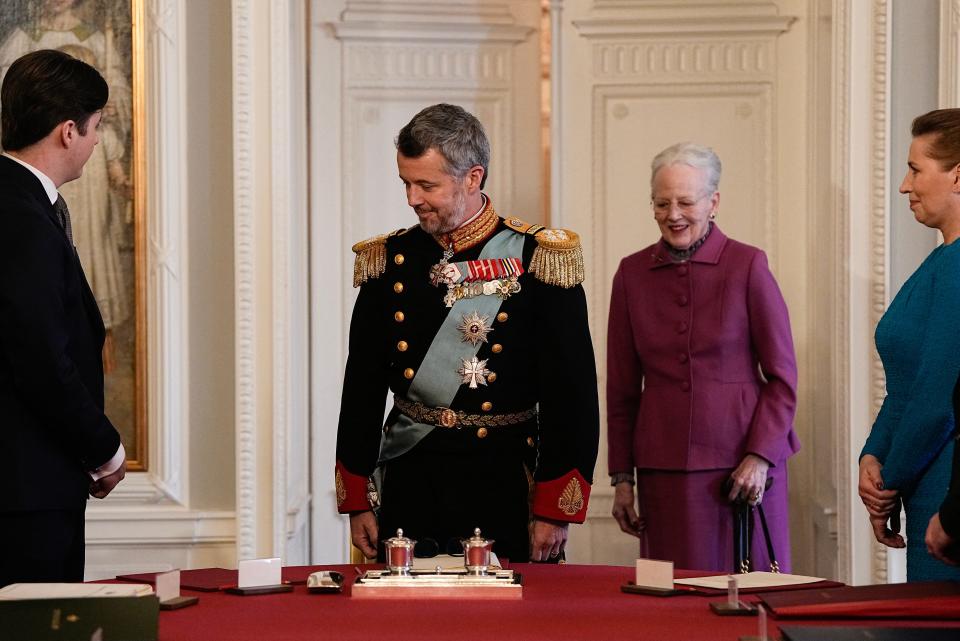 After signing the declaration of abdication Queen Margrethe II of Denmark (C-R) leaves the seat at the head of the table to her son King Frederik X of Denmark.