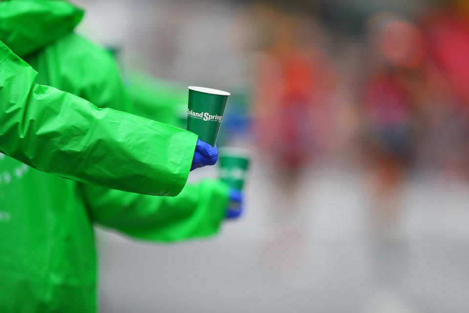 <p>Volunteers hold out cups of water for runners during the 2017 New York City Marathon, Nov. 5, 2017. (Photo: Gordon Donovan/Yahoo News) </p>